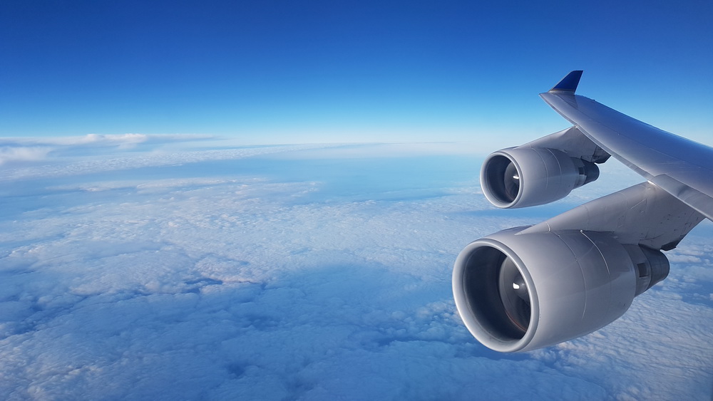 a plane wing with the sky above