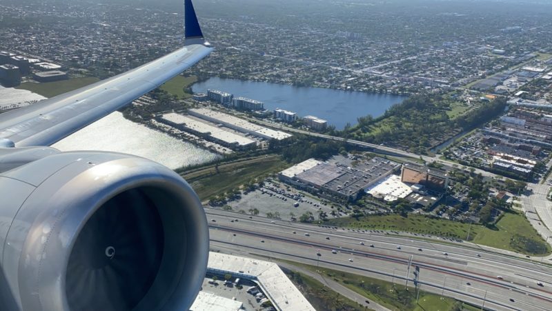 an airplane wing and a body of water