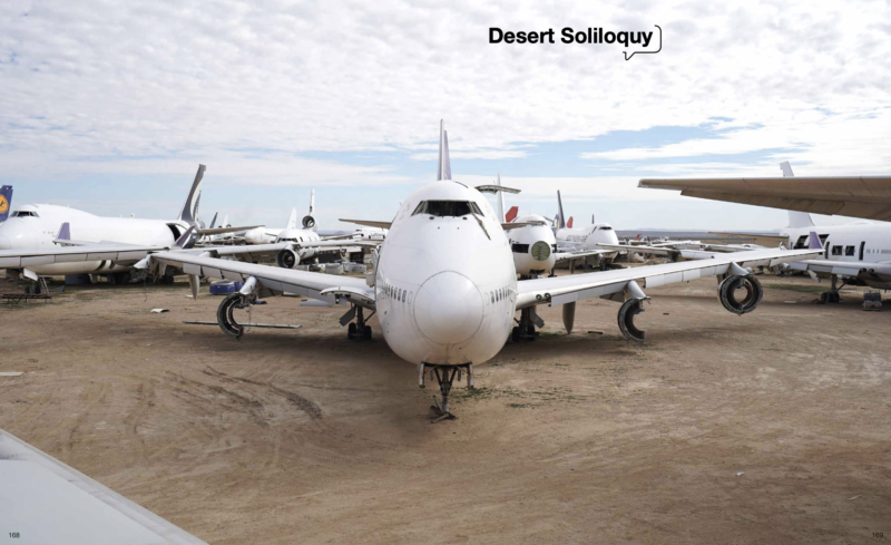 a group of airplanes parked on a dirt field